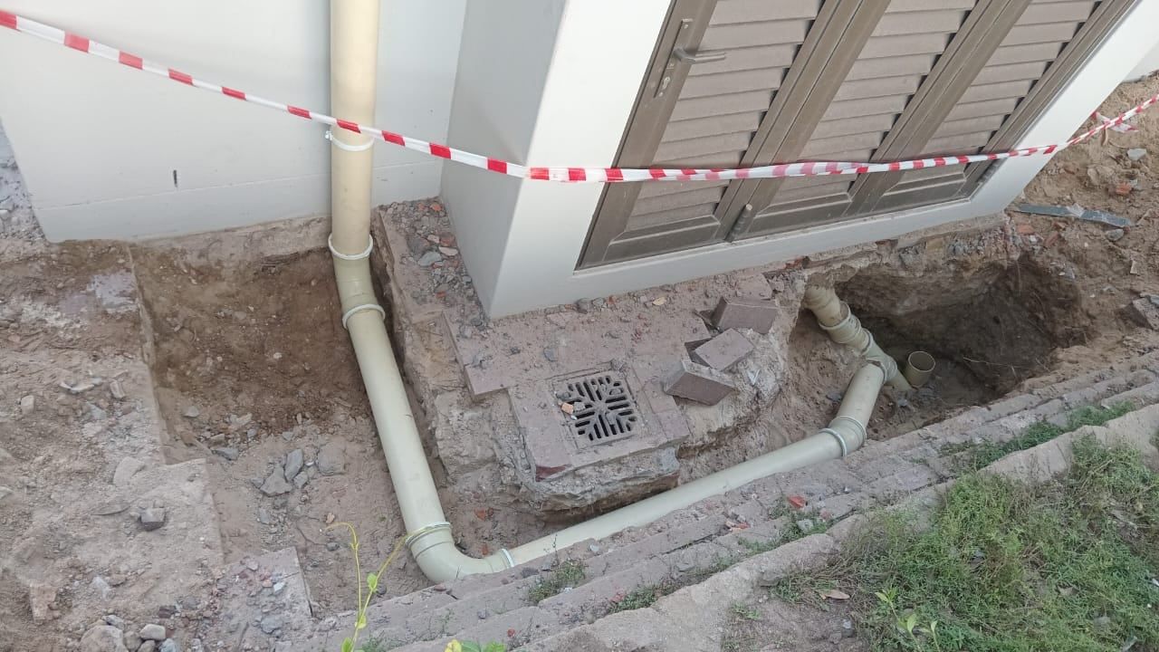 An outside gully and drain pipes being repaired