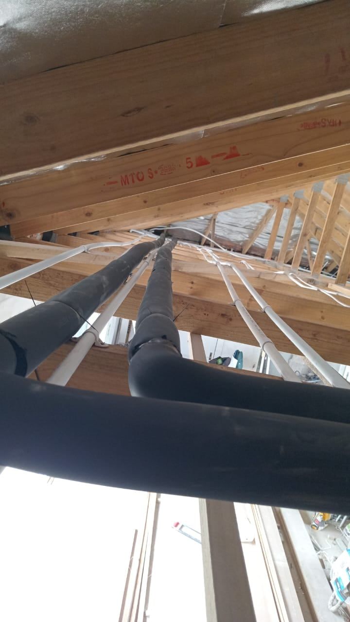 Lagged hot-water pipes running from a geyser through the roof space